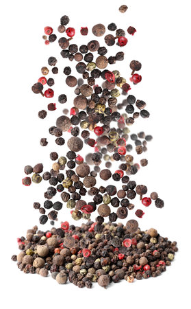 Different peppercorns falling into pile on white backgroundの写真素材