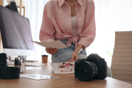 Professional photographer working in light modern office, closeupの写真素材