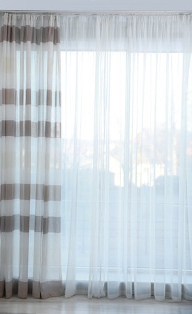 Window with elegant curtains in empty roomの写真素材