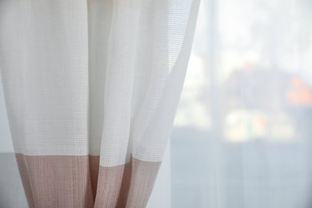 Window with elegant curtains indoors, closeup viewの写真素材