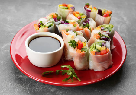 Delicious rolls wrapped in rice paper served on gray tableの写真素材