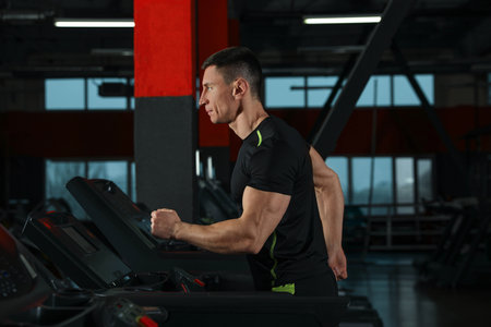 Man working out on treadmill in modern gym