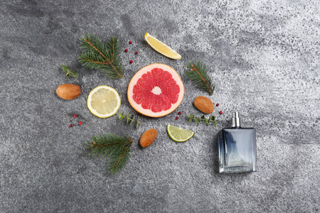 Flat lay composition with bottle of perfume on gray background