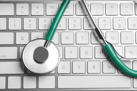 Stethoscope on keyboard, top view. Concept of technical supportの写真素材