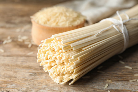 Raw rice noodles on wooden table, closeupの写真素材
