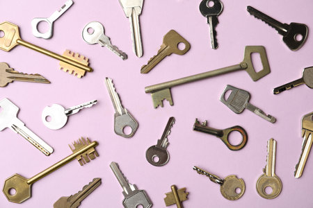 Steel keys on pink background, flat lay. safety conceptの写真素材