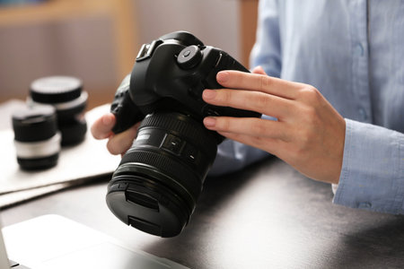 Journalist with camera working at table, closeupの写真素材
