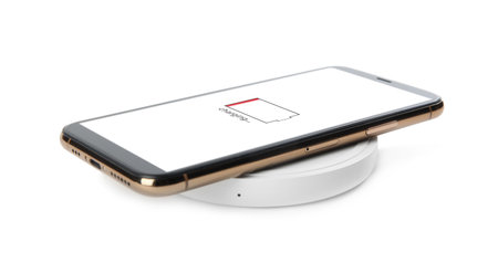 Mobile phone charging with wireless pad isolated on white