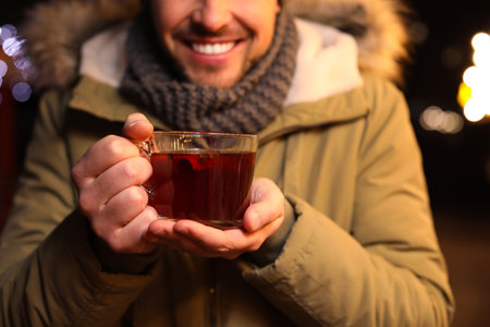 Happy man with mulled wine at winter fair, closeupの写真素材