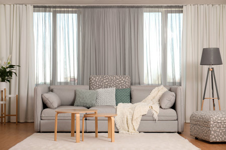 Windows with stylish curtains in living room interiorの写真素材