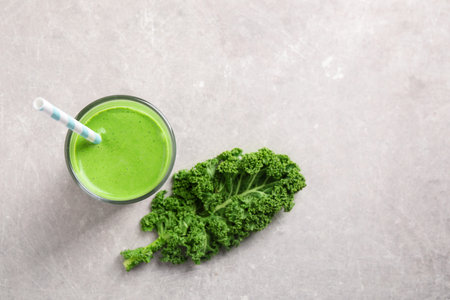 Tasty kale smoothie on light gray marble table, flat layの写真素材