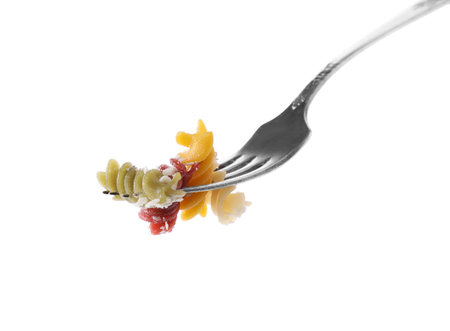 Fork with delicious spiraline pasta isolated on whiteの写真素材