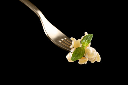 Fork with delicious fusilli pasta on black backgroundの写真素材