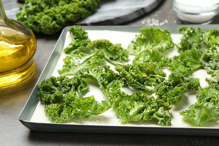 Raw cabbage leaves on gray table, closeup. Preparing kale chipsの写真素材