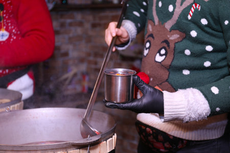 Seller with tasty mulled wine at winter fair, closeupの写真素材