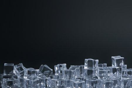 Crystal clear ice cubes on black background. Space for textの写真素材