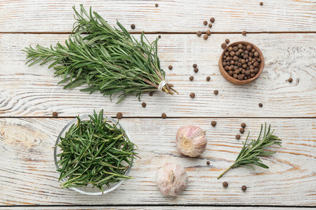 Flat lay composition with fresh rosemary on white wooden tableの写真素材