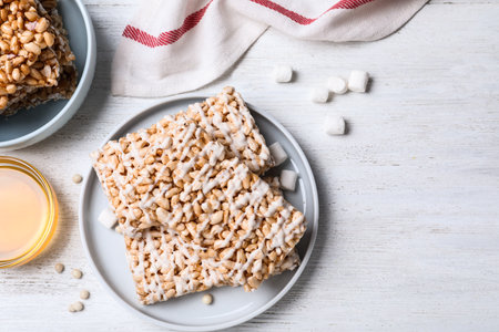 Delicious rice crispy treats on white wooden table, flat layの写真素材