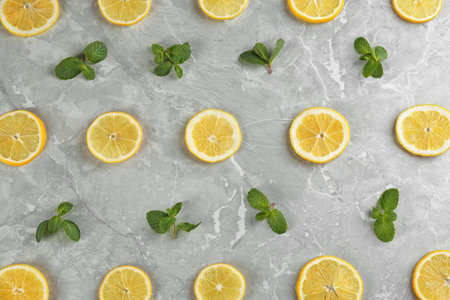 Lemonade layout with juicy lemon slices and mint on gray marble table, top viewの写真素材
