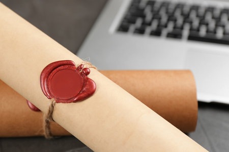 Document with notary's wax stamp on gray table, closeupの写真素材
