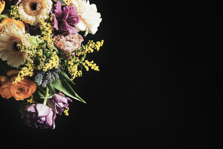 Beautiful bouquet of different flowers on black background, space for text. Floral card design with dark vintage effectの写真素材
