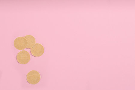 Sticking plasters on pink background, flat lay. Space for textの写真素材