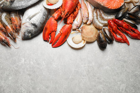 Fresh fish and seafood on marble table, flat lay. Space for textの写真素材