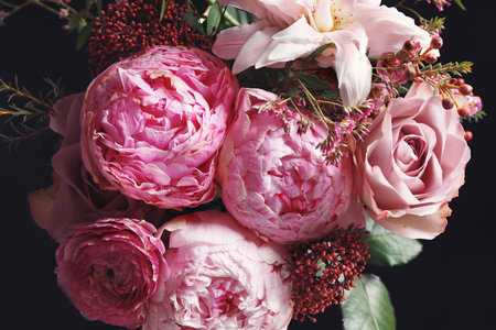 Beautiful bouquet of different flowers on black background, closeup. Floral card design with dark vintage effectの写真素材