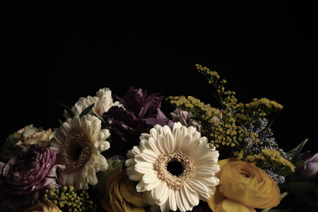 Beautiful bouquet of different flowers on black background. Floral card design with dark vintage...