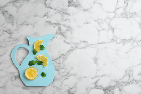 Creative lemonade layout with lemon slices and mint on white marble table, top view. Space for textの写真素材