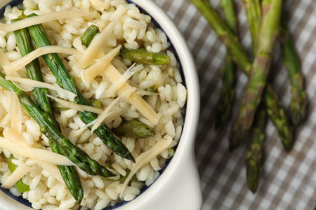 Delicious risotto with asparagus served on table, closeupの写真素材