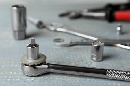 Auto mechanic's tool on gray wooden table, closeup