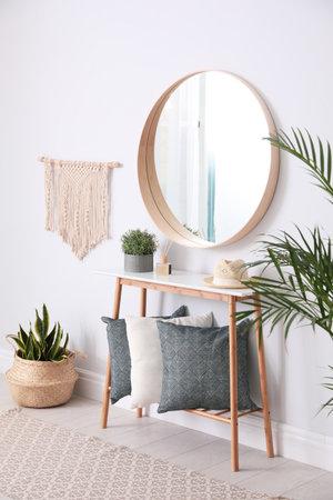 Round mirror and wooden table at home. Idea for interior designの写真素材