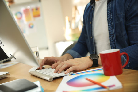 Professional designer working with computer in office, closeupの写真素材