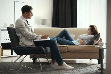 Professional psychotherapist working with patient in officeの写真素材