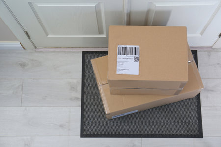 Cardboard boxes on rug near door, top view. Parcel delivery serviceの写真素材