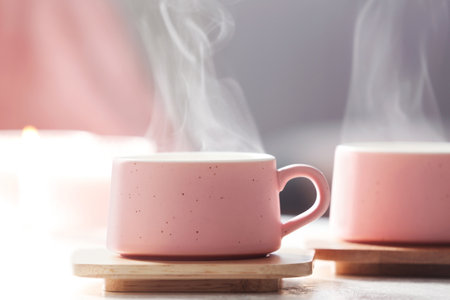 Cup of hot drink on white table against blurred backgroundの写真素材