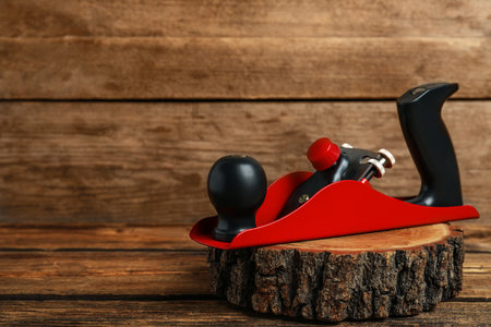 Wooden cut with jack plane on table, space for text. Carpenter's tool