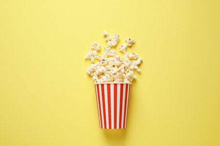 Delicious popcorn on yellow background, top viewの写真素材