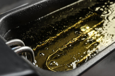 Hot cooking oil in deep fryer, closeupの写真素材