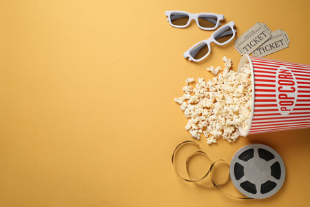 Flat lay composition with delicious popcorn on yellow background. Space for textの写真素材