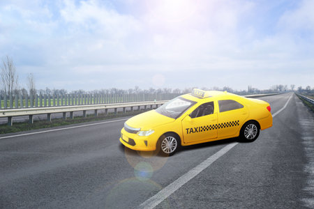 Yellow taxi car on asphalt highway outdoorsの写真素材