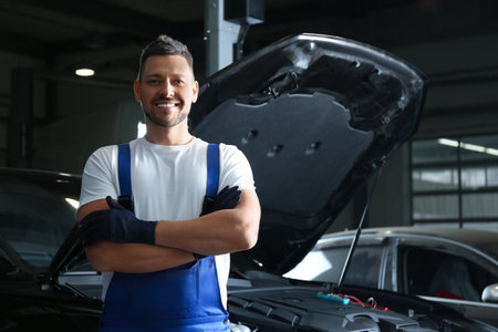 Mechanic near automobile in service center, space for text. car diagnosticの写真素材