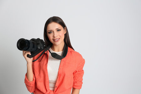 Professional photographer working on white background in studioの写真素材