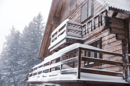 Modern wooden cottage on snowy day. winter holidays