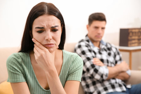 Unhappy woman after quarrel with her boyfriend at home. relationship problemsの写真素材
