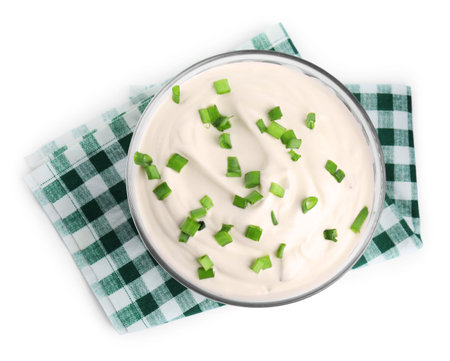 Fresh sour cream with onion and fabric on white background, top viewの写真素材