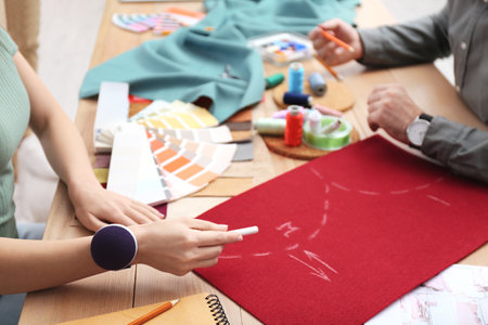 Fashion designers creating new clothes at table in studio, closeupの写真素材