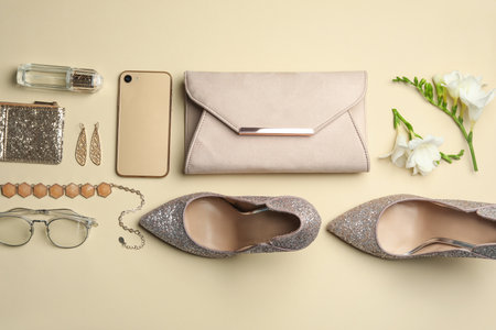 Flat lay composition with stylish woman's bag, smartphone and accessories on beige backgroundの写真素材
