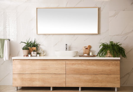 Stylish bathroom interior with countertop, mirror and houseplants. design ideasの写真素材